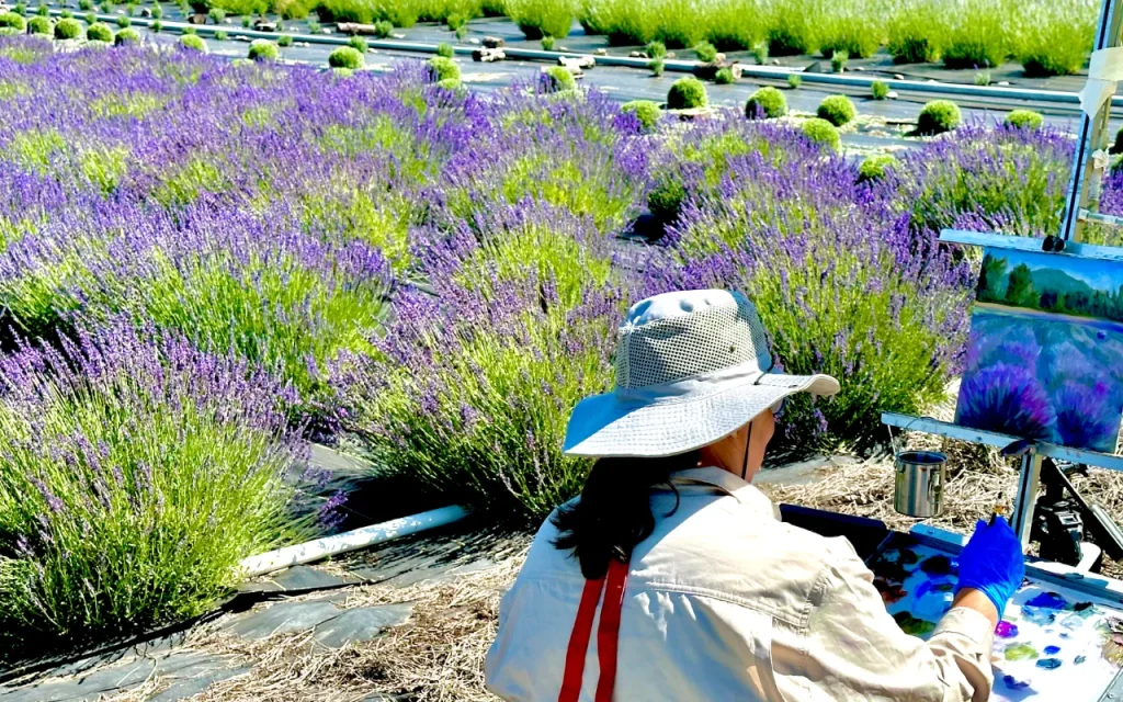Image shows artist painting the lavender bloom at McKenzie River Lavender